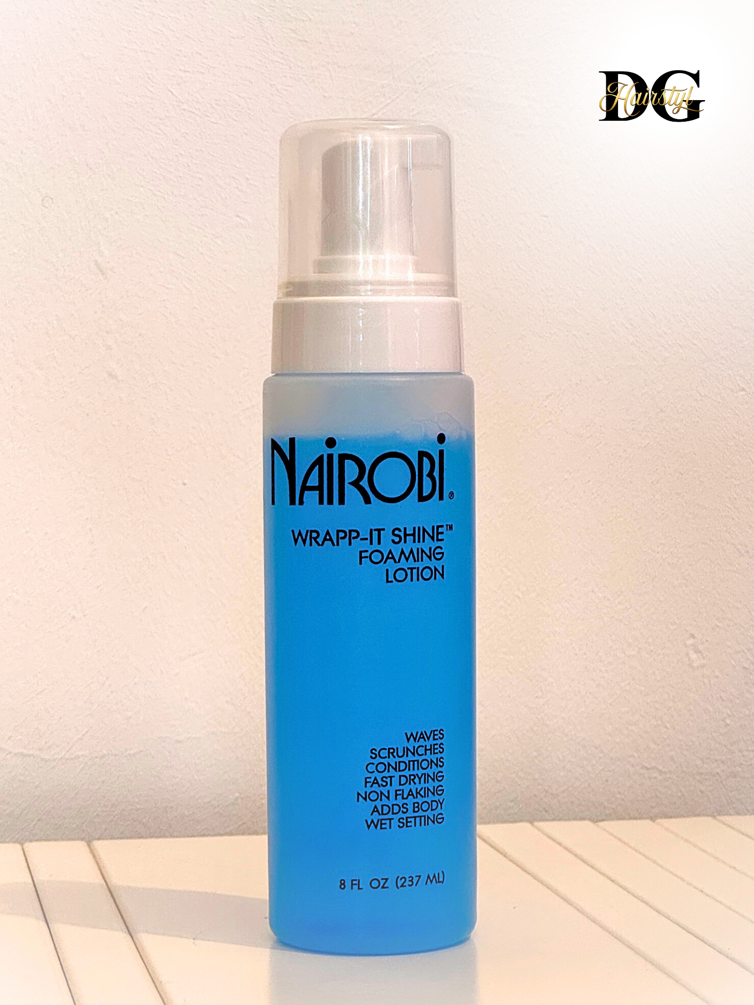 Nairobi Foaming Lotion for wrap sets, natural styles, and wig installs, adds shine and hold without flaking, available at DGHairstyl